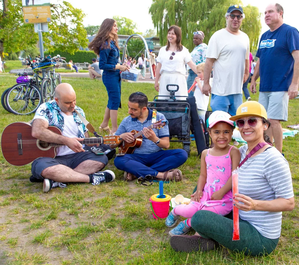 Families and friends gathered around live music outdoors