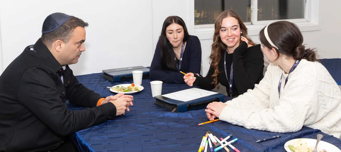 Participants gathered around a table for a leadership discussion