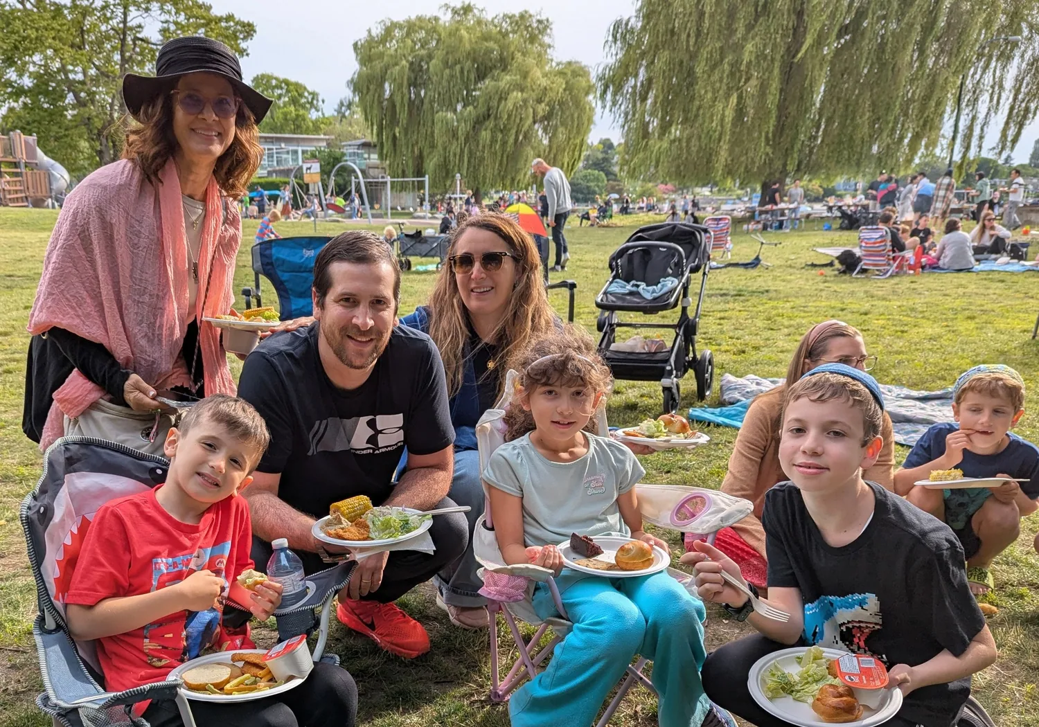 Families and friends gathered outdoors for Shabbat