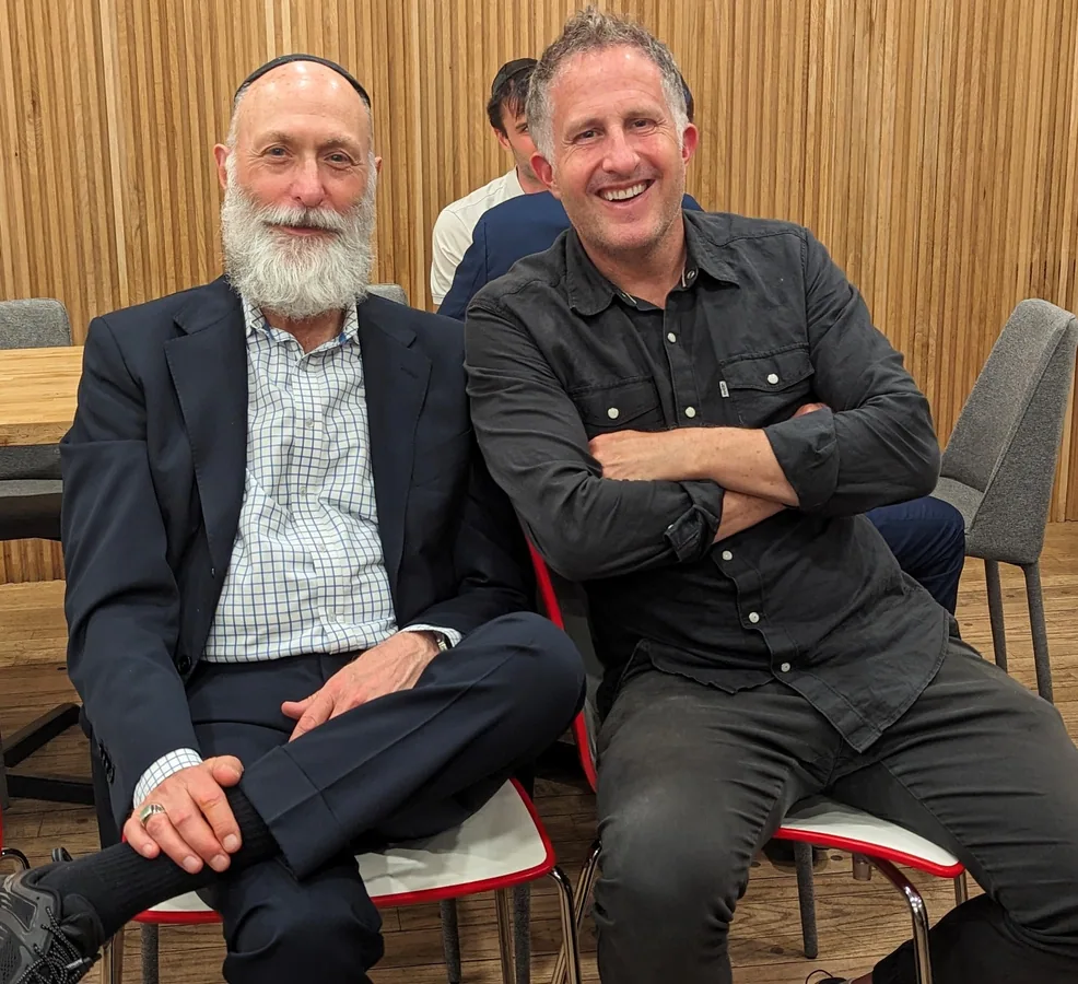 Friends smiling together at a Kollel community gathering