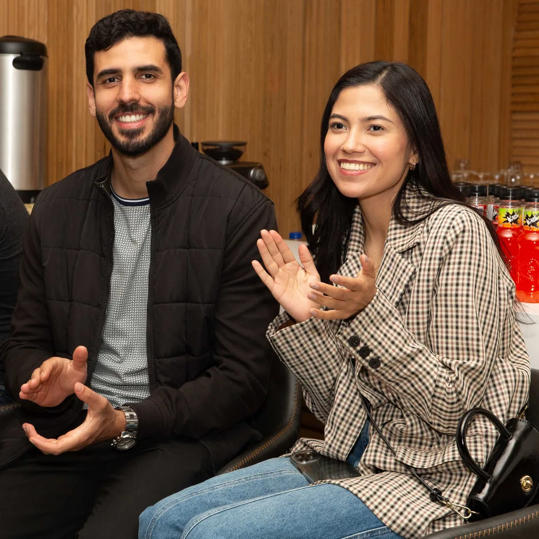 Two young adults in conversation at a community gathering