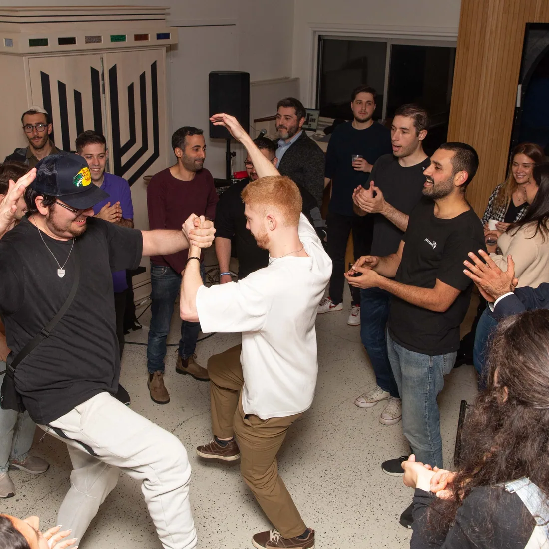 Young adults dancing together at a community celebration